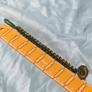 Green and cream and multicolored beads in this bracelet with lampwork clasp.